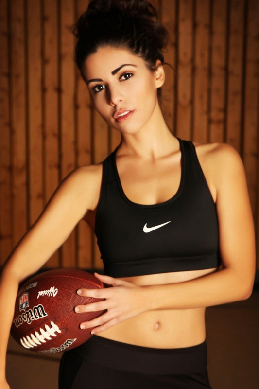 Model mit einem Rugbyball in der Hand